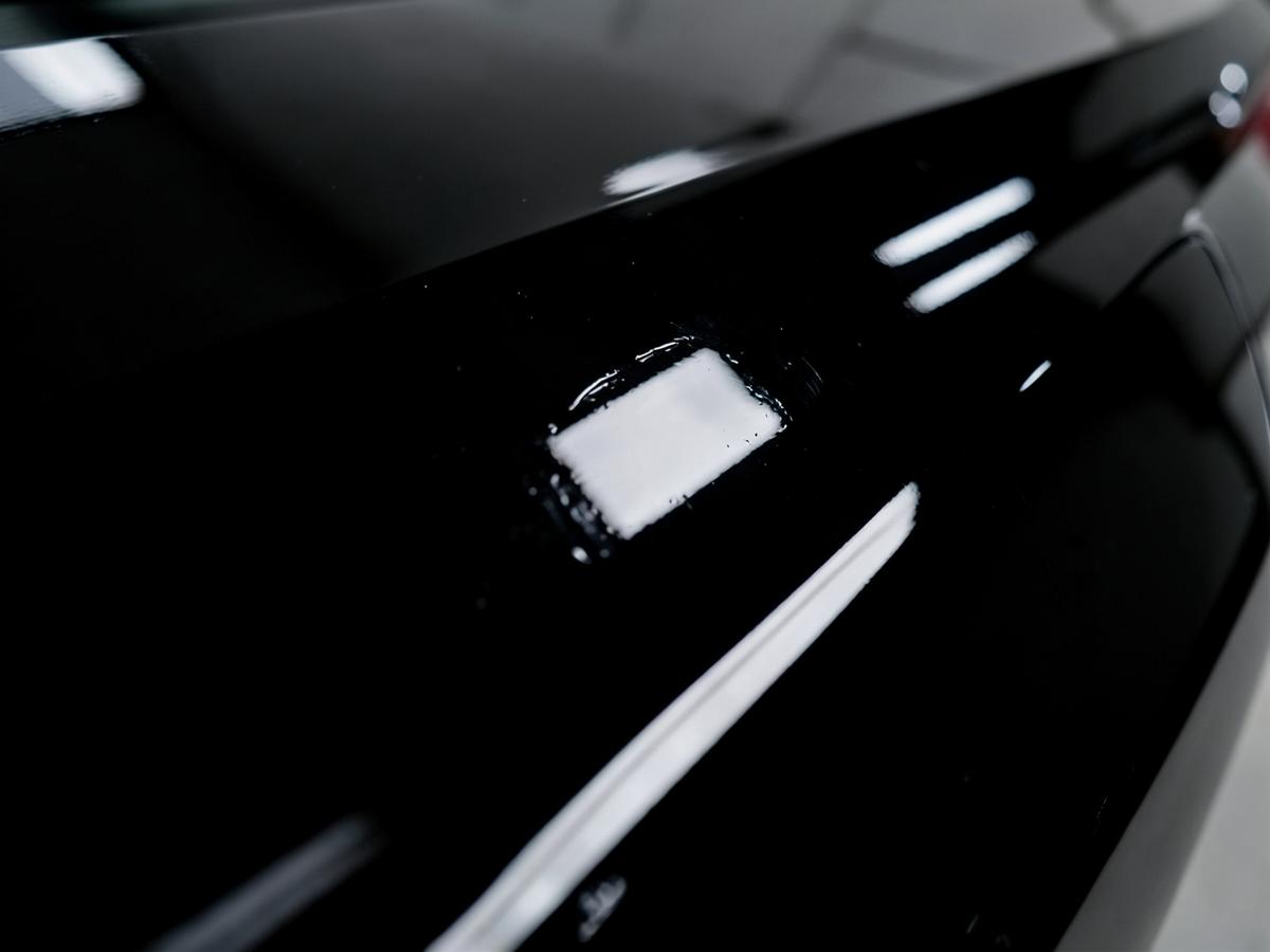 Mirror gloss black paint after professional paint correction and ceramic coating