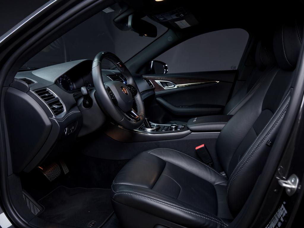 Restored black leather luxury car interior after deep cleaning